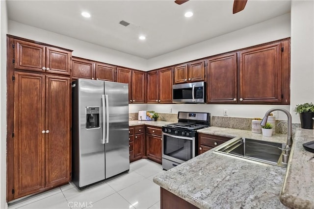 27831 Silverton Ct, Valencia, CA 91354 - kitchen with stainless steel appliances, a ceiling fan, light tile patterned floors, recessed lighting, and light stone counters