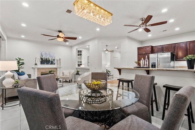 27831 Silverton Ct, Valencia, CA 91354 - dining room featuring ceiling fan, recessed lighting, and a fireplace
