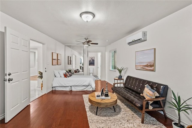 27831 Silverton Ct, Valencia, CA 91354 - bedroom featuring a wall unit AC, dark wood finished floors, a ceiling fan, and connected bathroom