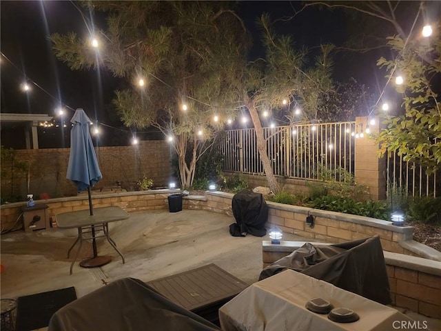 27831 Silverton Ct, Valencia, CA 91354 - patio at night with a patio, a fenced backyard, and grilling area