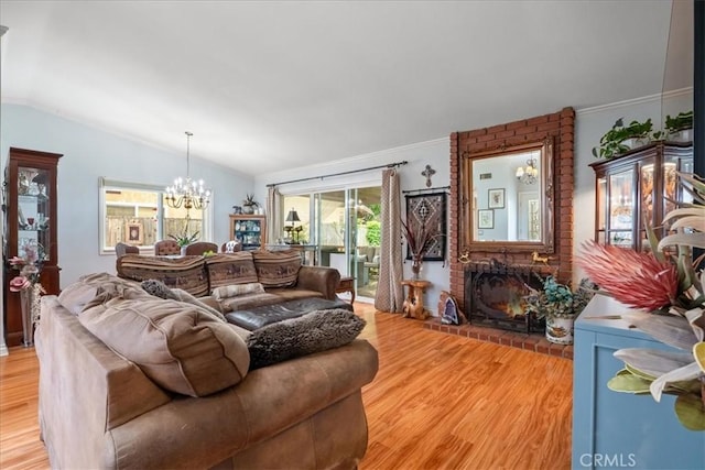 849 Shade Tree Ln, Fallbrook, CA 92028 - living area with light wood-style flooring, a chandelier, a fireplace, and vaulted ceiling