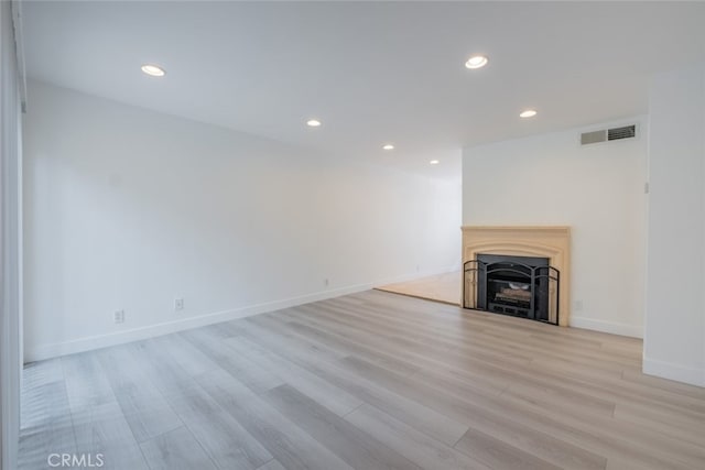 7741 Via Napoli Unit 77, Burbank, CA 91504 - unfurnished living room featuring recessed lighting, light wood-style floors, and a fireplace