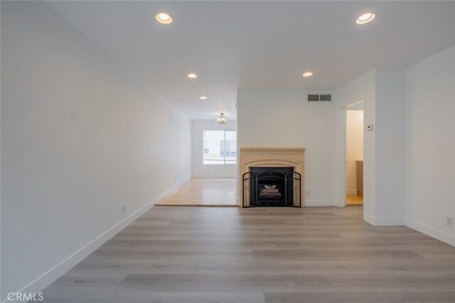 7741 Via Napoli Unit 77, Burbank, CA 91504 - unfurnished living room featuring recessed lighting, light wood finished floors, and a fireplace