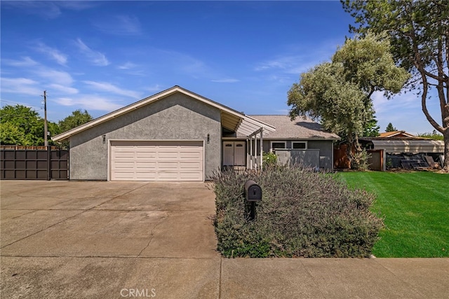 1720 N Cherry St, Chico, CA 95926 - ranch-style house featuring stucco siding, an attached garage, and concrete driveway