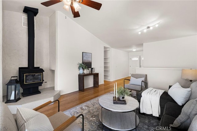 1720 N Cherry St, Chico, CA 95926 - living room with a wood stove, ceiling fan, wood finished floors, lofted ceiling, and built in shelves
