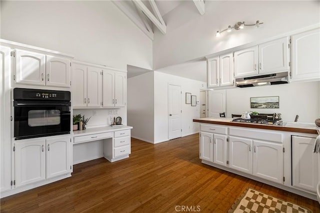 1720 N Cherry St, Chico, CA 95926 - kitchen featuring black oven, under cabinet range hood, a towering ceiling, stainless steel gas cooktop, and white cabinets