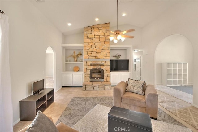 8250 Snow Cap Ave, Pinon Hills, CA 92372 - living area with arched walkways, built in features, ceiling fan, high vaulted ceiling, and a stone fireplace