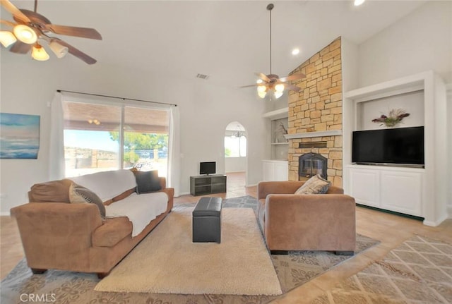 8250 Snow Cap Ave, Pinon Hills, CA 92372 - living room featuring a ceiling fan, built in features, high vaulted ceiling, a stone fireplace, and recessed lighting