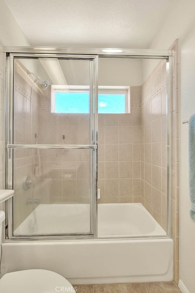 8250 Snow Cap Ave, Pinon Hills, CA 92372 - bathroom featuring bath / shower combo with glass door and toilet