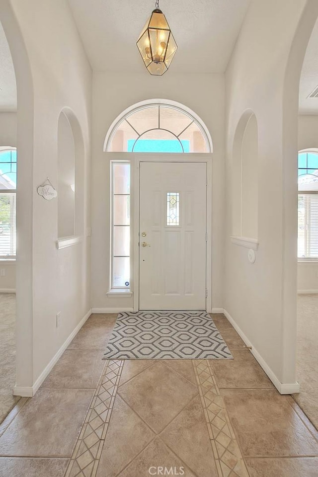 8250 Snow Cap Ave, Pinon Hills, CA 92372 - entrance foyer featuring baseboards, light tile patterned flooring, and arched walkways