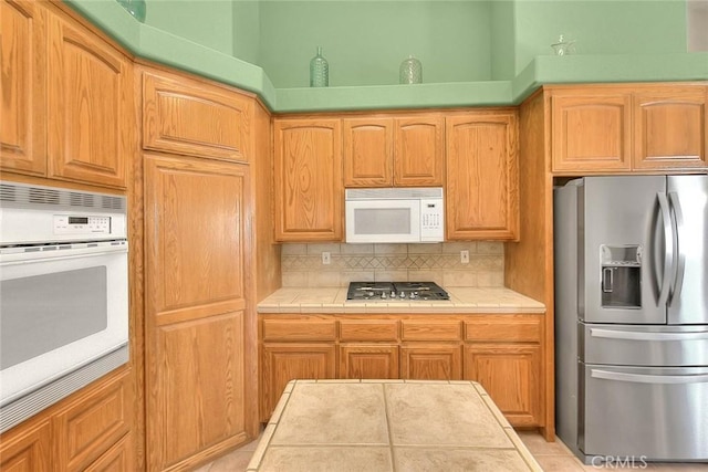 8250 Snow Cap Ave, Pinon Hills, CA 92372 - kitchen with stainless steel appliances, tile countertops, and decorative backsplash