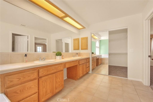 8250 Snow Cap Ave, Pinon Hills, CA 92372 - bathroom featuring double vanity, tile patterned floors, healthy amount of natural light, and decorative backsplash