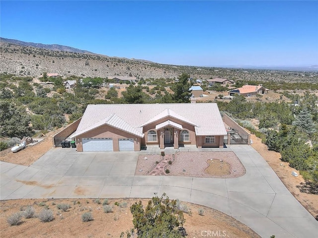 8250 Snow Cap Ave, Pinon Hills, CA 92372 - single story home with driveway, an attached garage, a mountain view, and a tiled roof