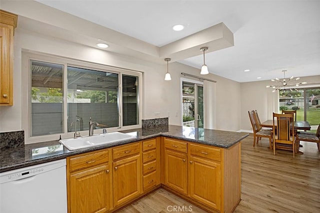 27262 Via Callejon Unit B, San Juan Capistrano, CA 92675 - kitchen with dishwasher, light wood-type flooring, a peninsula, hanging light fixtures, and dark stone countertops