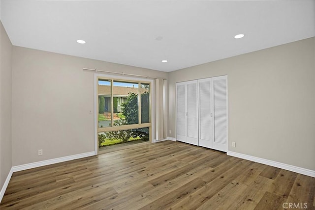 27262 Via Callejon Unit B, San Juan Capistrano, CA 92675 - unfurnished bedroom featuring wood finished floors, a closet, and recessed lighting