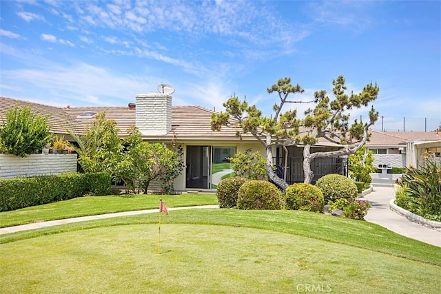 27262 Via Callejon Unit B, San Juan Capistrano, CA 92675 - view of front of home featuring a chimney, an area to practice putting, a tile roof, and a front yard