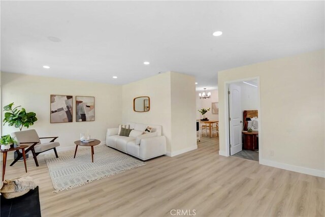 1024 E Dore St, West Covina, CA 91792 - living area featuring light wood-type flooring, a chandelier, baseboards, and recessed lighting
