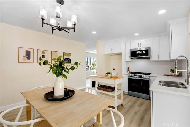 1024 E Dore St, West Covina, CA 91792 - dining space with light wood-style floors, recessed lighting, a chandelier, and baseboards