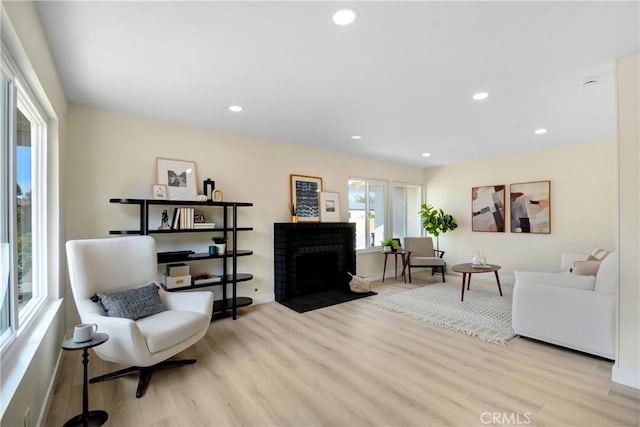 1024 E Dore St, West Covina, CA 91792 - living area with wood finished floors, a fireplace, recessed lighting, and baseboards