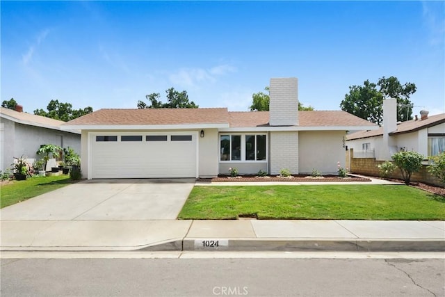 1024 E Dore St, West Covina, CA 91792 - ranch-style home with a garage, a front yard, concrete driveway, a chimney, and stucco siding