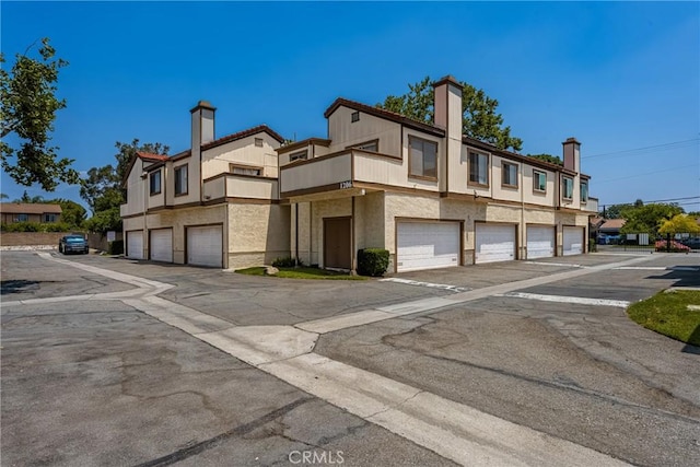 1206 S Cypress Ave Unit F, Ontario, CA 91762 - view of building exterior featuring a garage and driveway