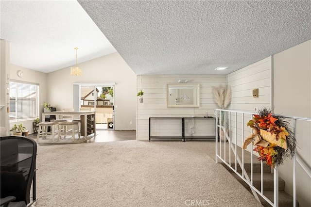 1206 S Cypress Ave Unit F, Ontario, CA 91762 - carpeted living room featuring a textured ceiling and vaulted ceiling