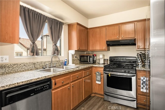 1206 S Cypress Ave Unit F, Ontario, CA 91762 - kitchen with stainless steel appliances, under cabinet range hood, a sink, dark wood-style floors, and brown cabinets