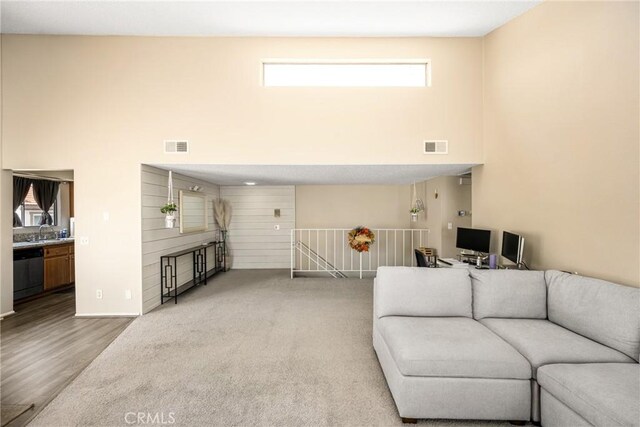 1206 S Cypress Ave Unit F, Ontario, CA 91762 - living room featuring a towering ceiling, an office area, and wood finished floors