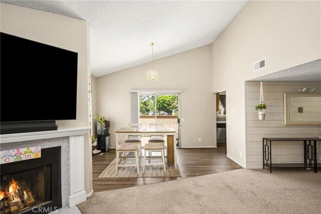 1206 S Cypress Ave Unit F, Ontario, CA 91762 - dining room featuring lofted ceiling, carpet floors, baseboards, and a high end fireplace