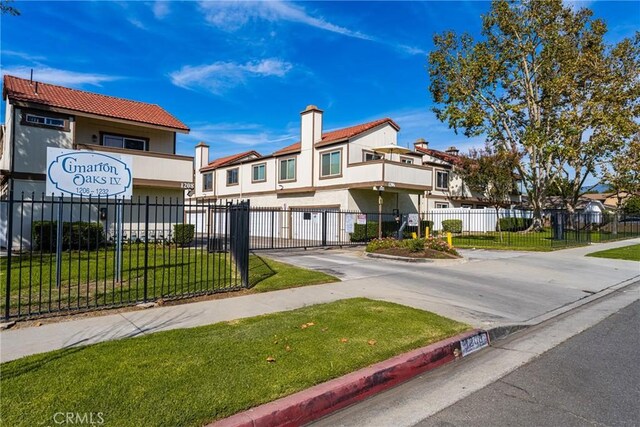 1206 S Cypress Ave Unit F, Ontario, CA 91762 - view of property with concrete driveway, a garage, a balcony, and stucco siding