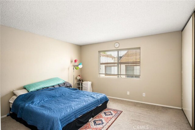 1206 S Cypress Ave Unit F, Ontario, CA 91762 - bedroom with carpet, a textured ceiling, and baseboards