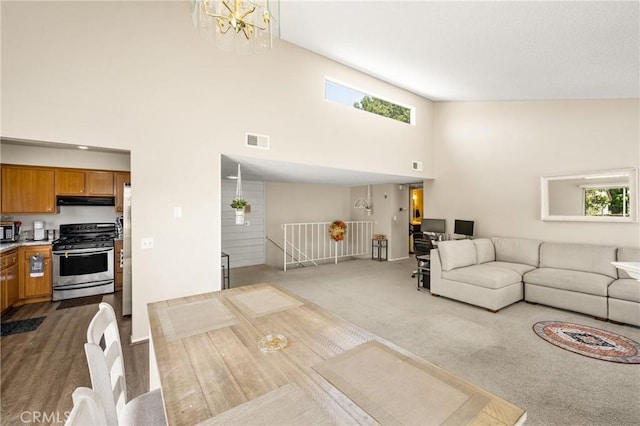 1206 S Cypress Ave Unit F, Ontario, CA 91762 - living area featuring plenty of natural light, a high ceiling, dark colored carpet, a chandelier, and baseboards