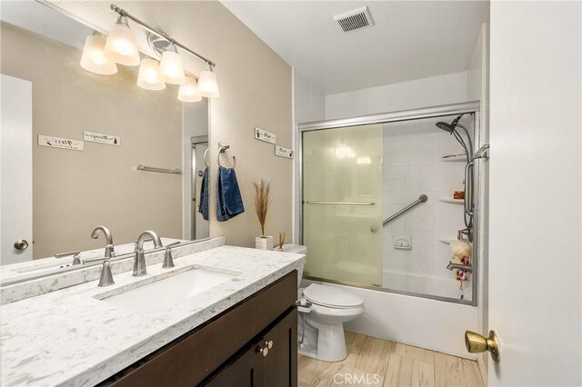 1206 S Cypress Ave Unit F, Ontario, CA 91762 - bathroom with vanity, toilet, combined bath / shower with glass door, and wood finished floors