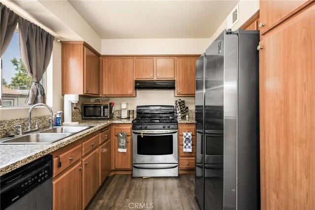 1206 S Cypress Ave Unit F, Ontario, CA 91762 - kitchen with appliances with stainless steel finishes, under cabinet range hood, a sink, dark wood-type flooring, and brown cabinets