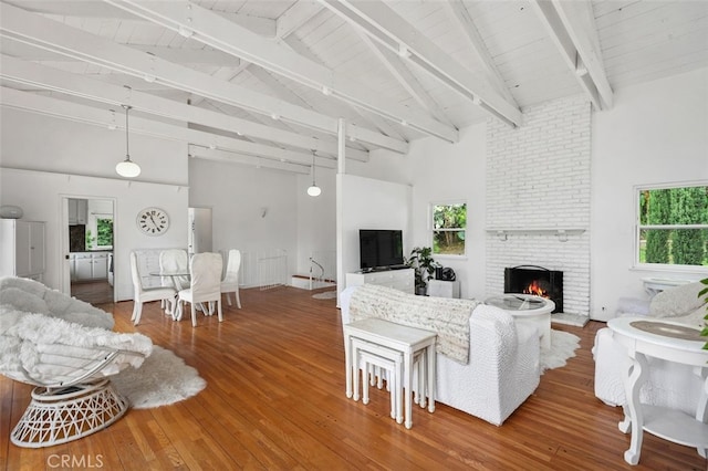 5245 Grandview Ave, Yorba Linda, CA 92886 - living room featuring high vaulted ceiling, hardwood / wood-style floors, a brick fireplace, and wooden ceiling with exposed beams