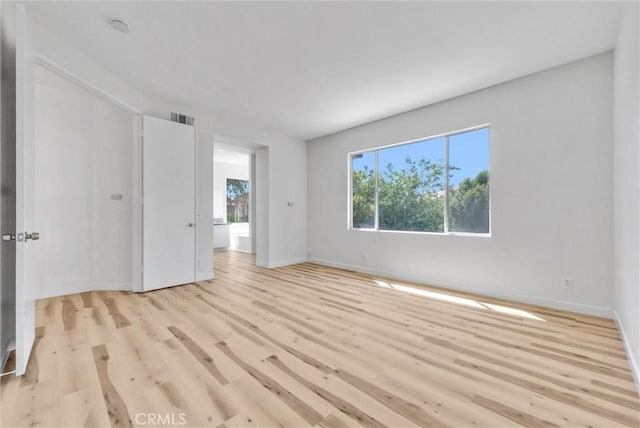 7522 Calais Ct, Rancho Cucamonga, CA 91730 - empty room with light wood finished floors, baseboards, and a smoke detector