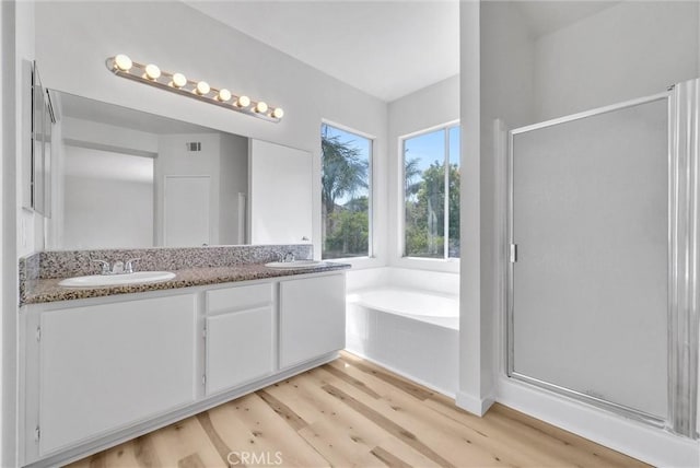 7522 Calais Ct, Rancho Cucamonga, CA 91730 - bathroom with wood finished floors, a stall shower, a garden tub, and double vanity