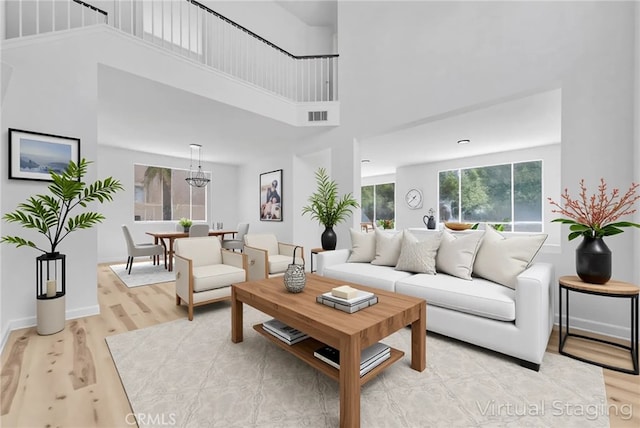 7522 Calais Ct, Rancho Cucamonga, CA 91730 - living area featuring a towering ceiling, light wood finished floors, and baseboards