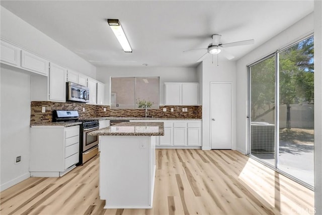 7522 Calais Ct, Rancho Cucamonga, CA 91730 - kitchen featuring appliances with stainless steel finishes, light wood finished floors, white cabinets, and backsplash