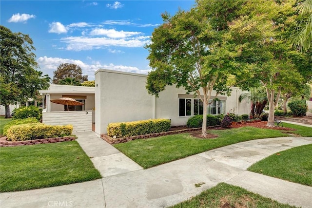 2160 Via Mariposa E Unit D, Laguna Woods, CA 92637 - view of front of home with a front lawn and stucco siding