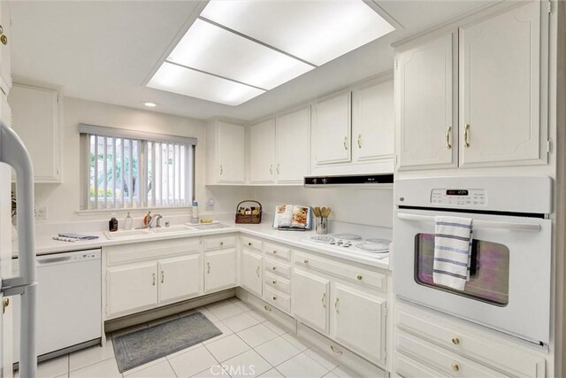 2160 Via Mariposa E Unit D, Laguna Woods, CA 92637 - kitchen featuring white appliances, a sink, light tile patterned flooring, light countertops, and white cabinetry