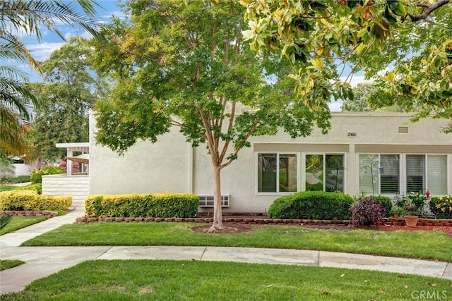 2160 Via Mariposa E Unit D, Laguna Woods, CA 92637 - view of front of house with stucco siding and a front lawn