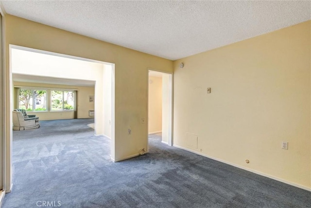 2160 Via Mariposa E Unit D, Laguna Woods, CA 92637 - spare room featuring carpet floors, a textured ceiling, and baseboards