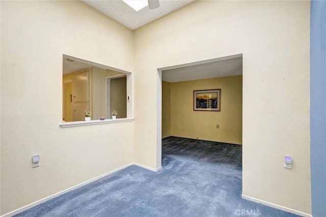 2160 Via Mariposa E Unit D, Laguna Woods, CA 92637 - empty room featuring dark colored carpet and baseboards