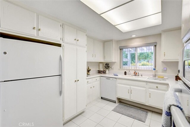 2160 Via Mariposa E Unit D, Laguna Woods, CA 92637 - kitchen featuring white appliances, a sink, light countertops, light tile patterned flooring, and white cabinetry
