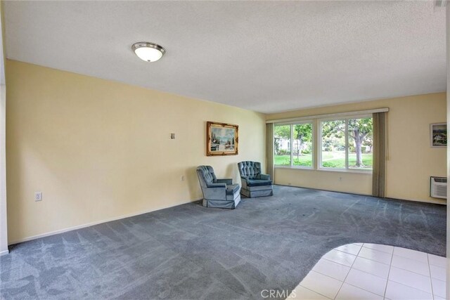 2160 Via Mariposa E Unit D, Laguna Woods, CA 92637 - unfurnished room with carpet, a textured ceiling, and an AC wall unit