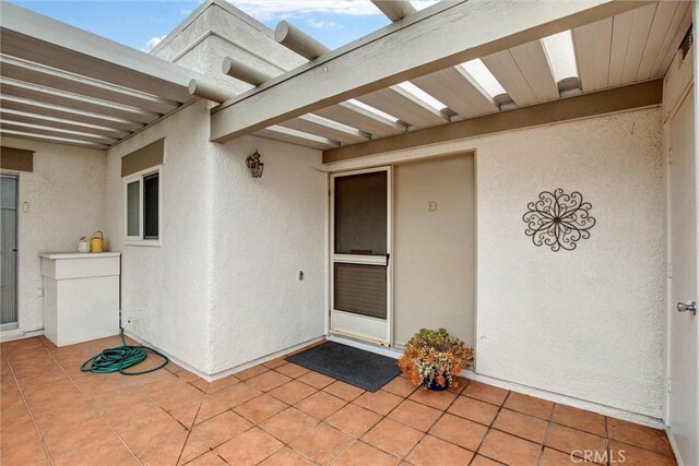 2160 Via Mariposa E Unit D, Laguna Woods, CA 92637 - property entrance featuring a patio and stucco siding