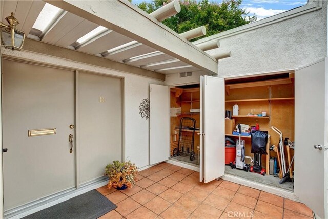 2160 Via Mariposa E Unit D, Laguna Woods, CA 92637 - doorway to property with stucco siding