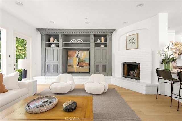 3 Seabluff, Newport Beach, CA 92660 - living room with light wood-style flooring, a brick fireplace, and recessed lighting