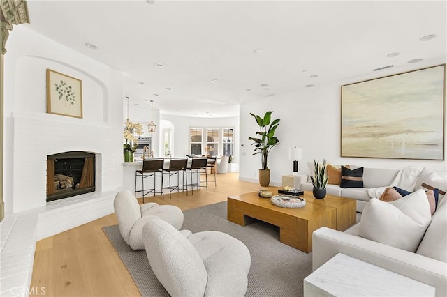 3 Seabluff, Newport Beach, CA 92660 - living room with light wood finished floors, recessed lighting, and a fireplace